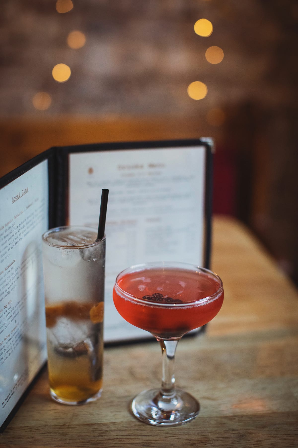 Cocktails on the table at The Warren, with the drinks menu behind