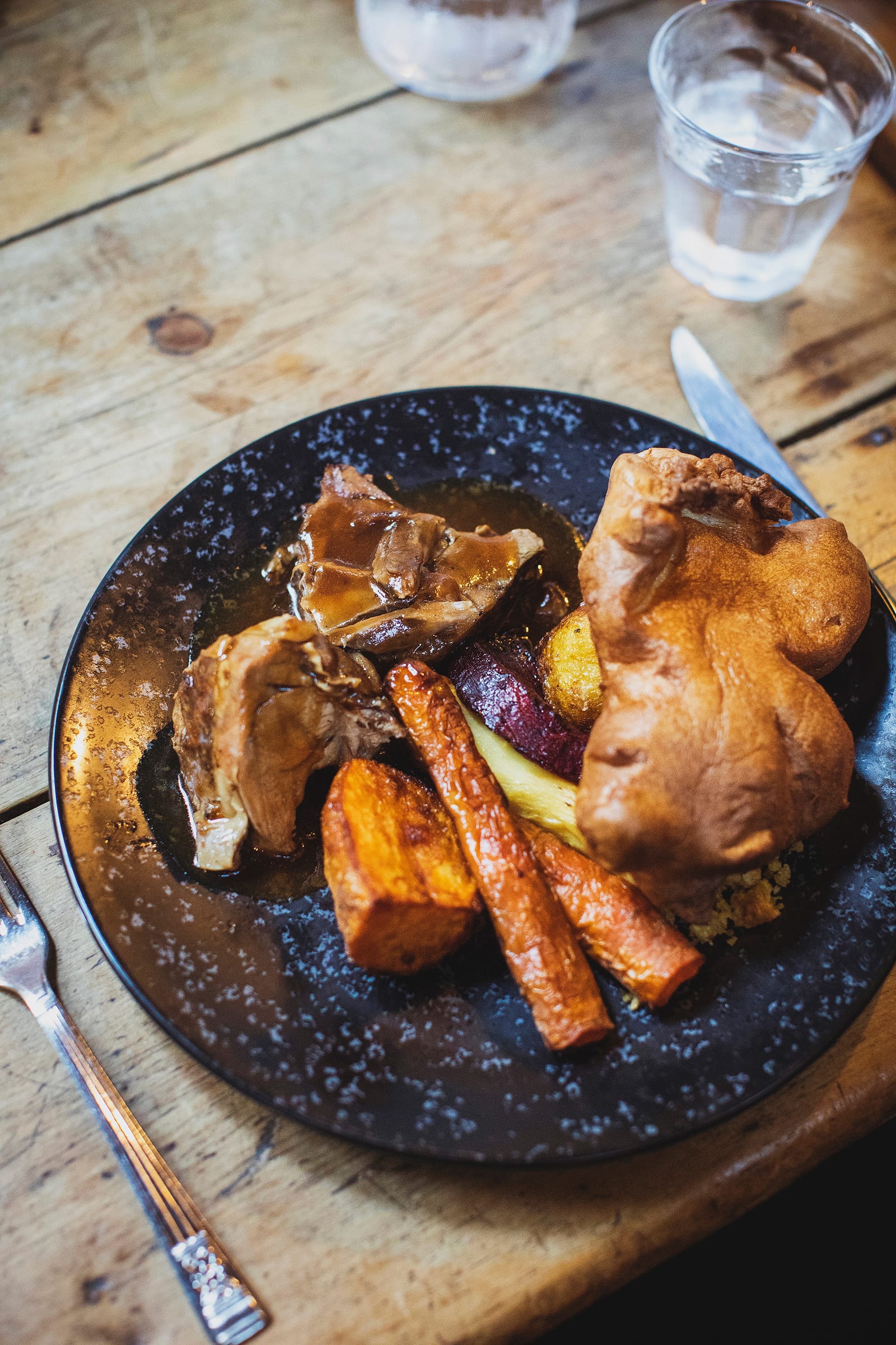 A Sunday roast with roast potatoes, carrots and gravy